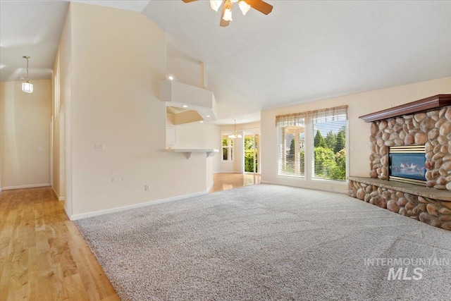 3314 S Raintree, Nampa, ID 83669 - unfurnished living room with a fireplace, a ceiling fan, light wood finished floors, lofted ceiling, and a chandelier