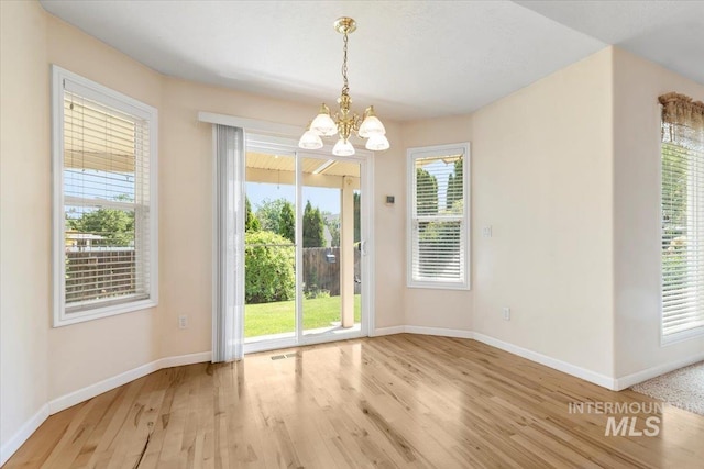3314 S Raintree, Nampa, ID 83669 - unfurnished dining area featuring wood finished floors and a chandelier