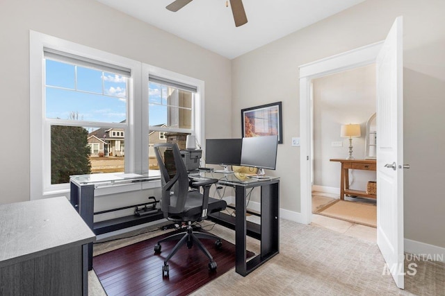 office area featuring ceiling fan and baseboards