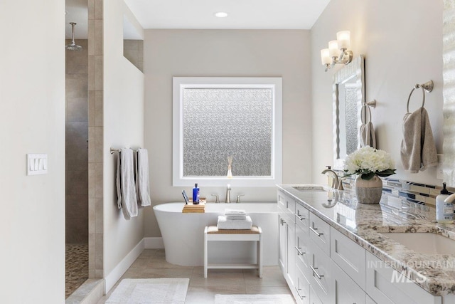 bathroom featuring a soaking tub, tile patterned flooring, walk in shower, and a sink