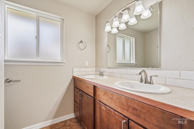 bathroom featuring double vanity, a healthy amount of sunlight, and a sink