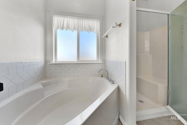 full bathroom with a garden tub and a shower stall