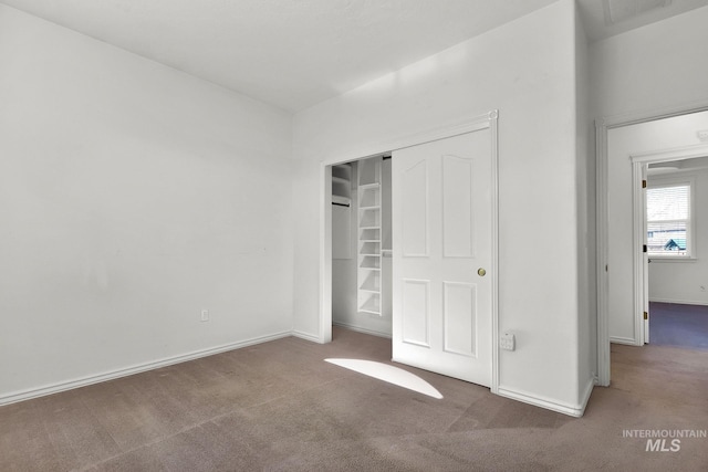 unfurnished bedroom featuring a closet, carpet flooring, and baseboards