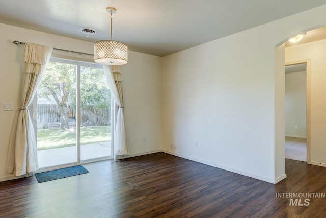 4935 N Rathbone Ave, Meridian, ID 83646 - spare room with dark wood-type flooring and arched walkways