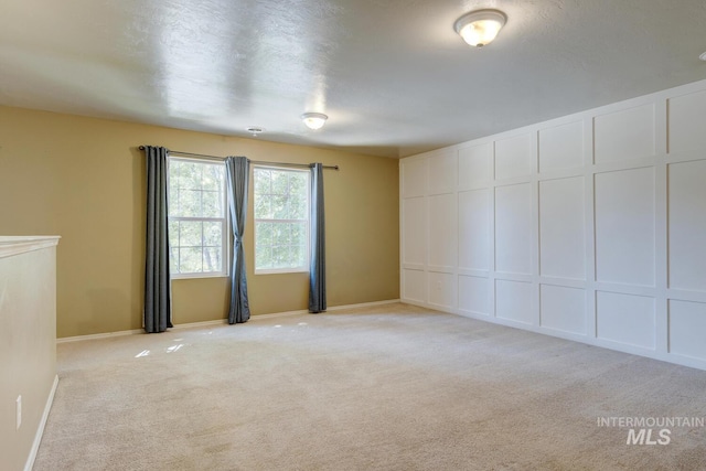 4935 N Rathbone Ave, Meridian, ID 83646 - spare room featuring light carpet and a decorative wall