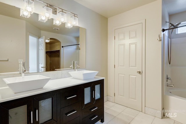 4935 N Rathbone Ave, Meridian, ID 83646 - bathroom featuring double vanity, shower / tub combination, tile patterned flooring, and a closet
