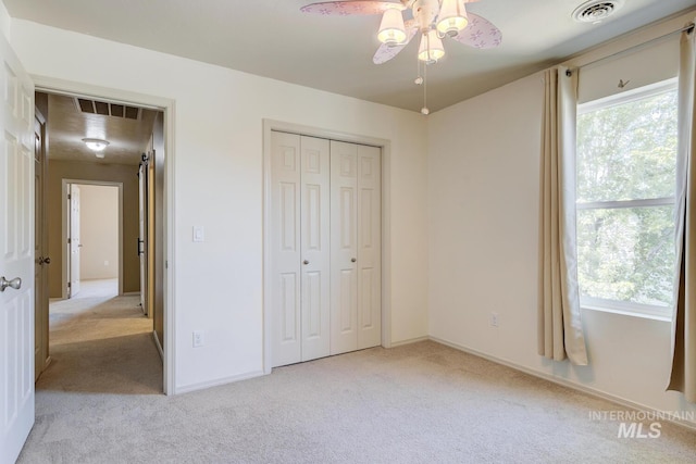 4935 N Rathbone Ave, Meridian, ID 83646 - unfurnished bedroom featuring light carpet, a closet, and a ceiling fan