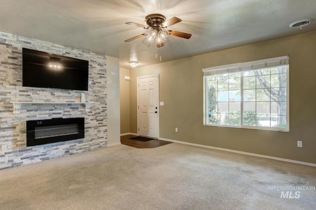 4935 N Rathbone Ave, Meridian, ID 83646 - unfurnished living room with ceiling fan, carpet, and a fireplace