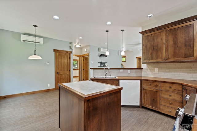 1649 Bear Trl, Donnelly, ID 83615 - kitchen featuring dishwasher, an AC wall unit, light wood finished floors, backsplash, and a center island
