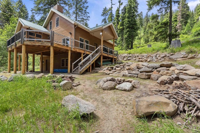 1649 Bear Trl, Donnelly, ID 83615 - rear view of house featuring a deck, a chimney, and stairway