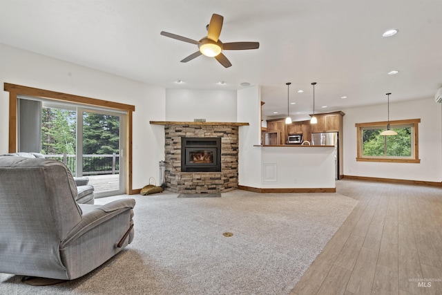 1649 Bear Trl, Donnelly, ID 83615 - living room featuring healthy amount of natural light, a ceiling fan, light wood-style floors, recessed lighting, and a stone fireplace