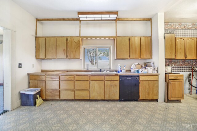 kitchen with backsplash, black dishwasher, and sink