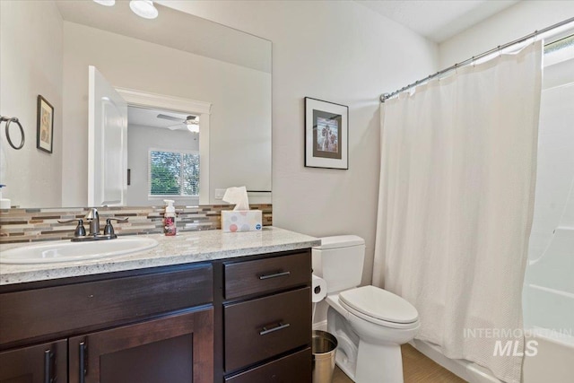 2706 E Rochester Ct, Meridian, ID 83646 - bathroom with vanity, backsplash, toilet, shower / tub combo with curtain, and a ceiling fan