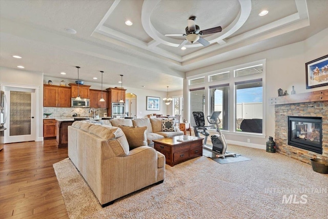 2706 E Rochester Ct, Meridian, ID 83646 - living room with recessed lighting, a ceiling fan, a fireplace, baseboards, and a chandelier