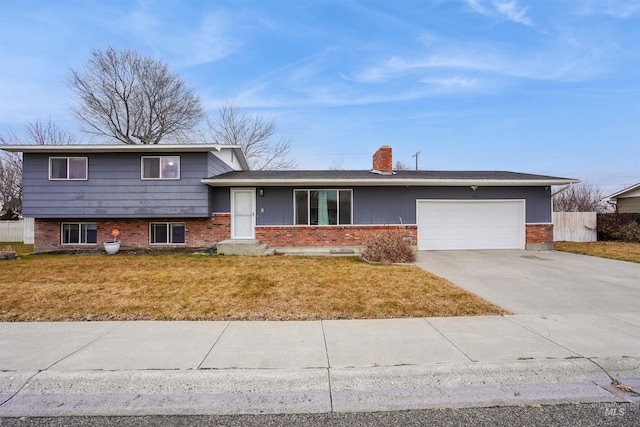 tri-level home with a garage and a front yard