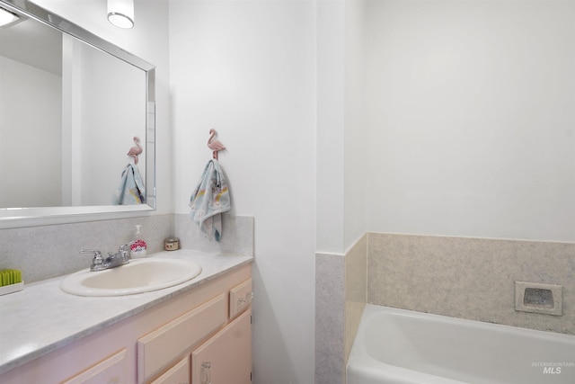 bathroom featuring a tub and vanity