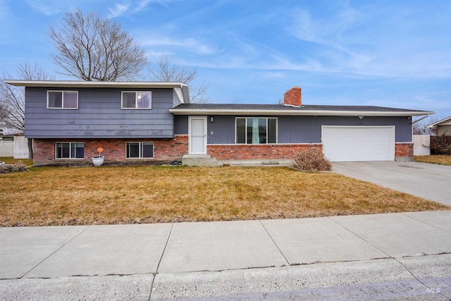 split level home featuring a front yard and a garage