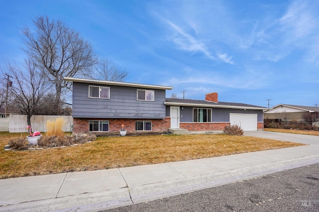 split level home featuring a front yard and a garage