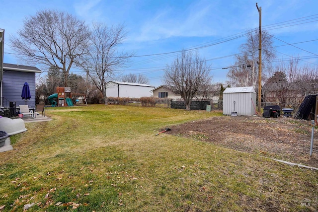 view of yard with a shed and a playground