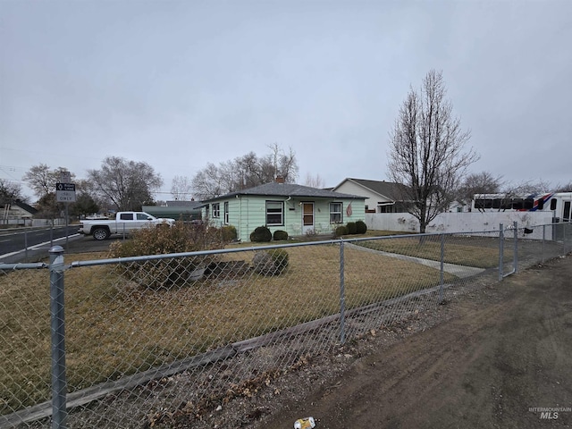 view of front of home featuring a front lawn and fence private yard