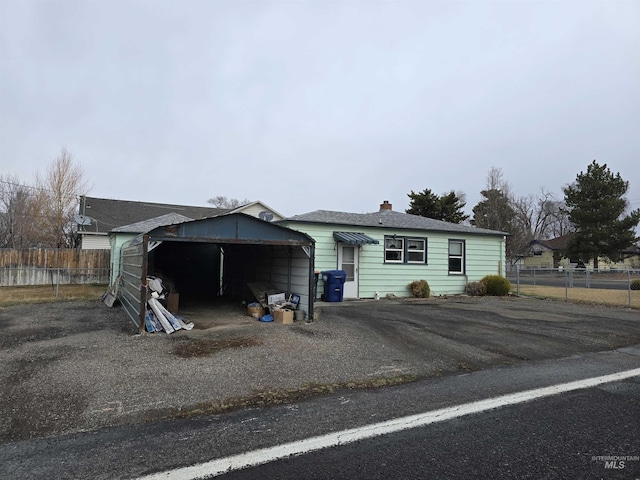 exterior space featuring driveway and fence