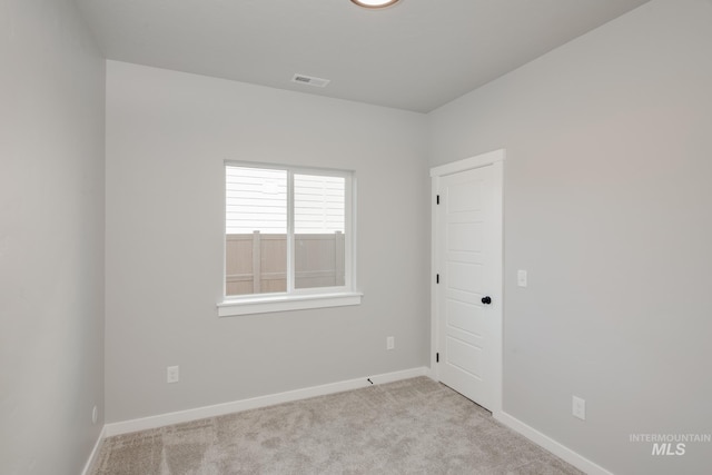 spare room with visible vents, carpet floors, and baseboards