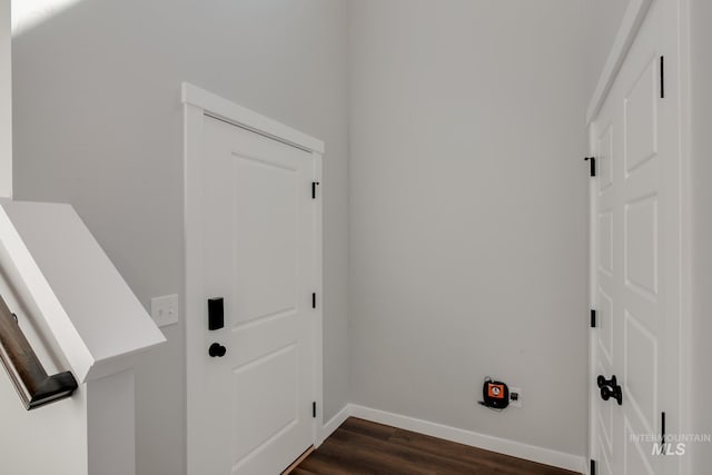 washroom featuring baseboards and dark wood-style floors