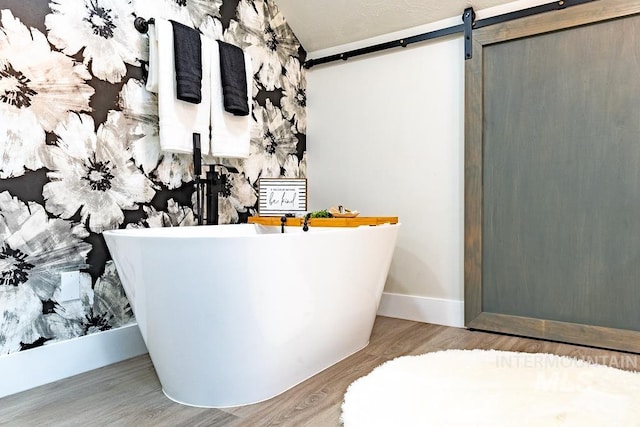 bathroom featuring hardwood / wood-style flooring and a bathtub