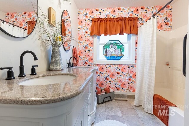 1302 1st Ave S, Payette, ID 83661 - full bath with vanity, wallpapered walls, and shower / tub combo