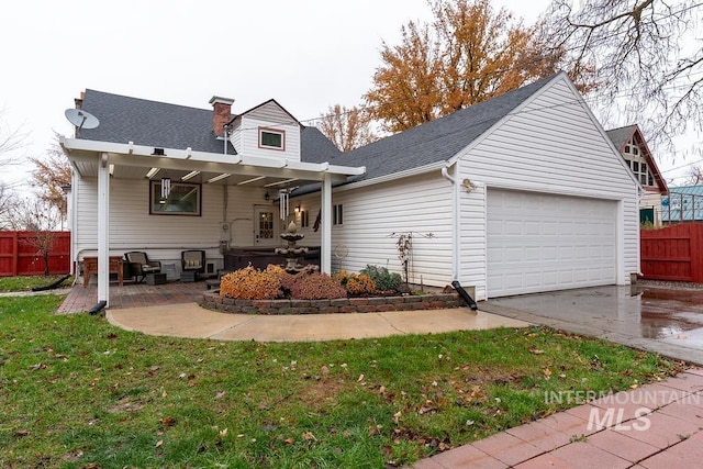 1302 1st Ave S, Payette, ID 83661 - back of property featuring concrete driveway, a garage, a chimney, and roof with shingles