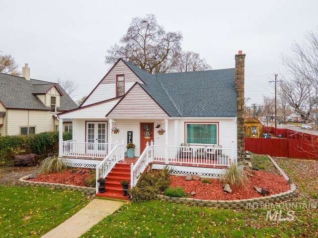 1302 1st Ave S, Payette, ID 83661 - bungalow featuring covered porch, french doors, a chimney, and roof with shingles