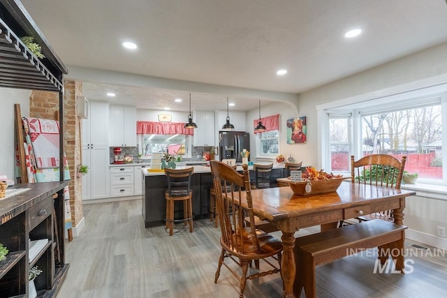 dining space with light hardwood / wood-style flooring