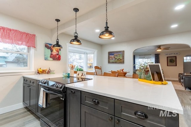 kitchen with light wood-type flooring, decorative light fixtures, black / electric stove, and ceiling fan