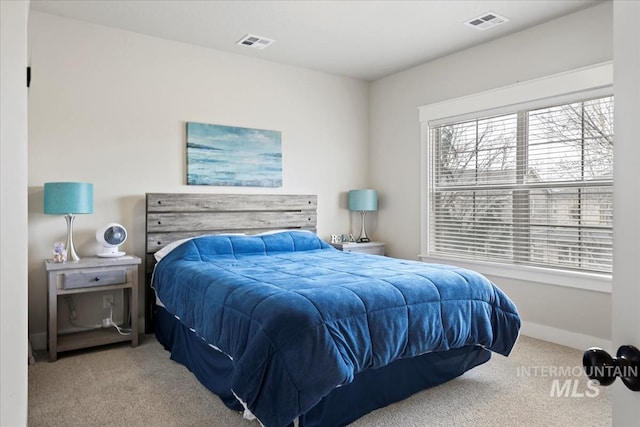 carpeted bedroom featuring visible vents and baseboards