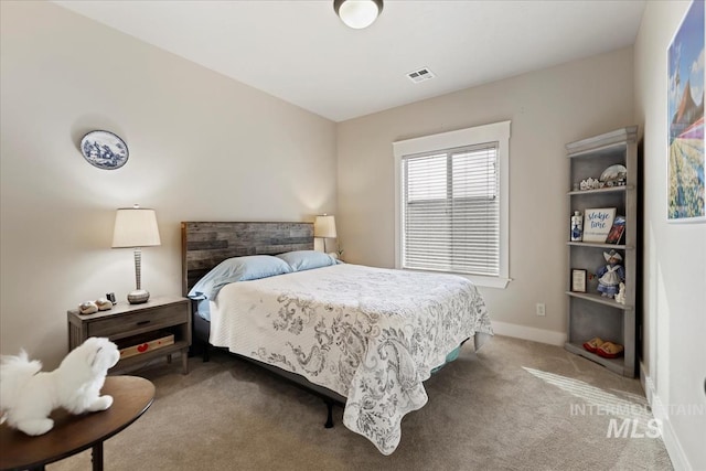 carpeted bedroom featuring visible vents and baseboards