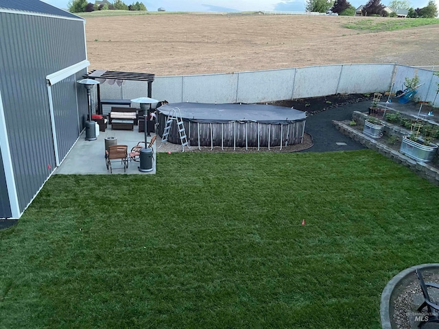 view of yard with an outdoor hangout area, a covered pool, and a patio area