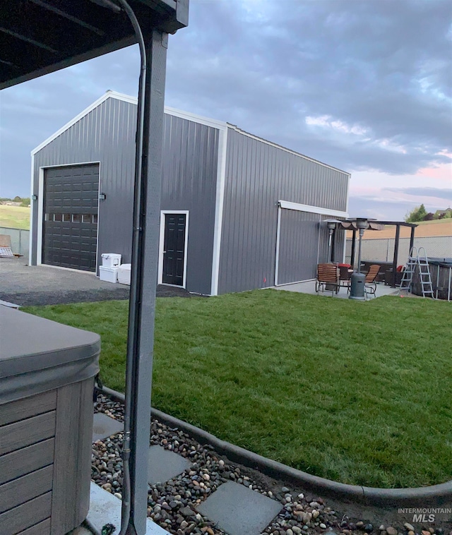 view of outbuilding featuring a lawn and a garage