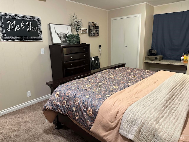 bedroom with ornamental molding, a closet, and carpet floors