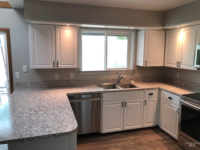 kitchen with appliances with stainless steel finishes, sink, and white cabinets