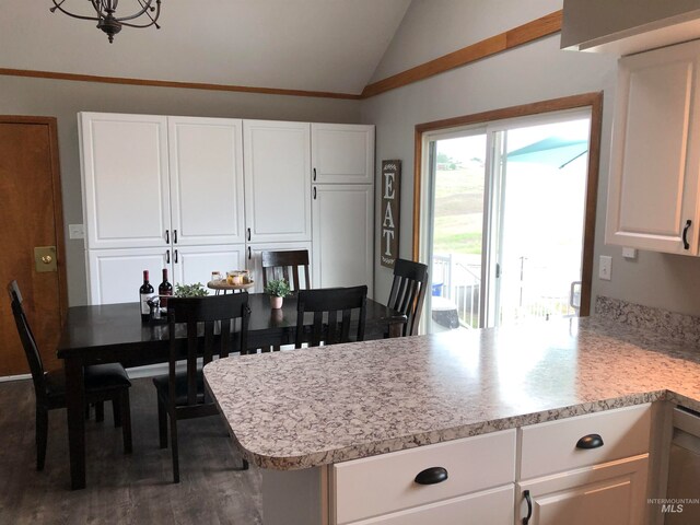 kitchen featuring lofted ceiling, white cabinetry, and kitchen peninsula