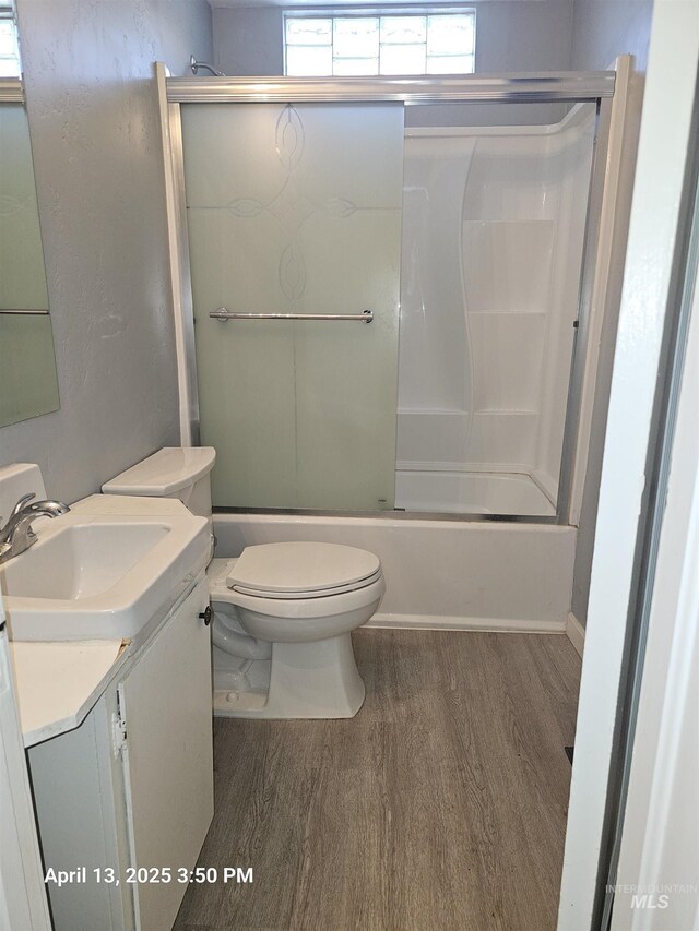 314 S Phillippi St, Boise, ID 83705 - bathroom featuring wood finished floors, vanity, toilet, and combined bath / shower with glass door
