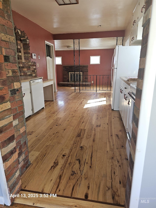 314 S Phillippi St, Boise, ID 83705 - kitchen with white dishwasher, light wood-type flooring, and white cabinetry