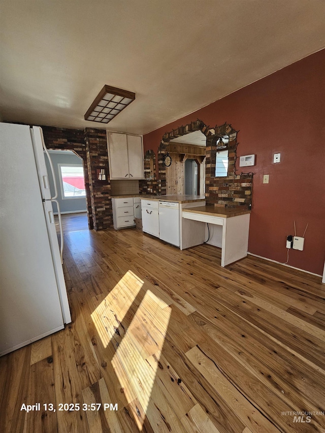 314 S Phillippi St, Boise, ID 83705 - kitchen featuring white appliances, wood-type flooring, a peninsula, white cabinets, and dark countertops