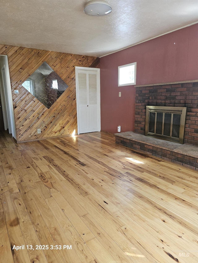 314 S Phillippi St, Boise, ID 83705 - unfurnished living room with wood walls, wood-type flooring, and a fireplace
