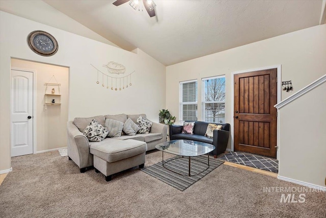 carpeted living room featuring ceiling fan and vaulted ceiling