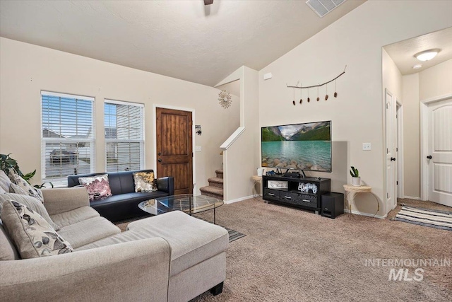 living room featuring carpet floors and high vaulted ceiling