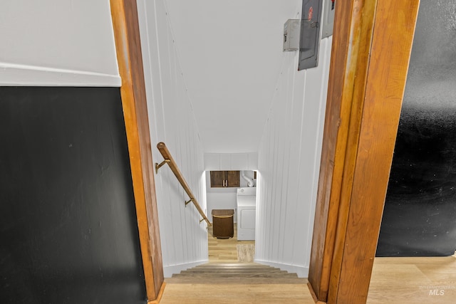staircase featuring washer / dryer and wood finished floors