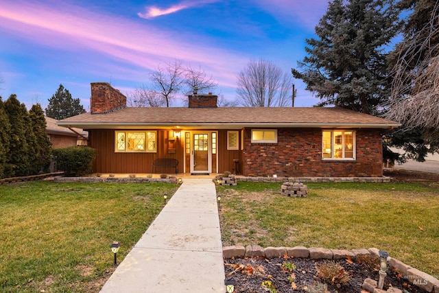 single story home featuring a porch, board and batten siding, a chimney, and a front lawn