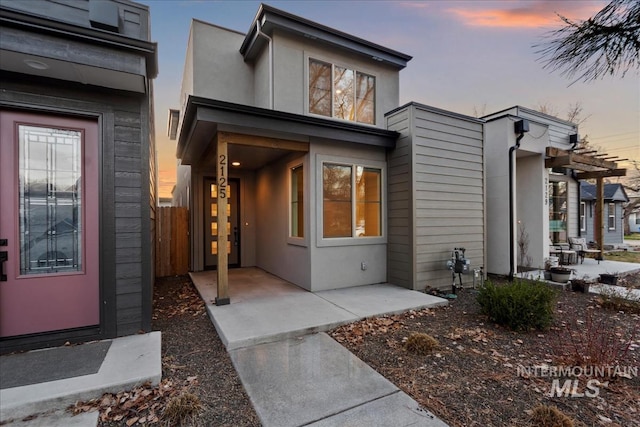 property entrance with stucco siding