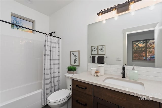 full bathroom featuring vanity, toilet, and shower / tub combo with curtain